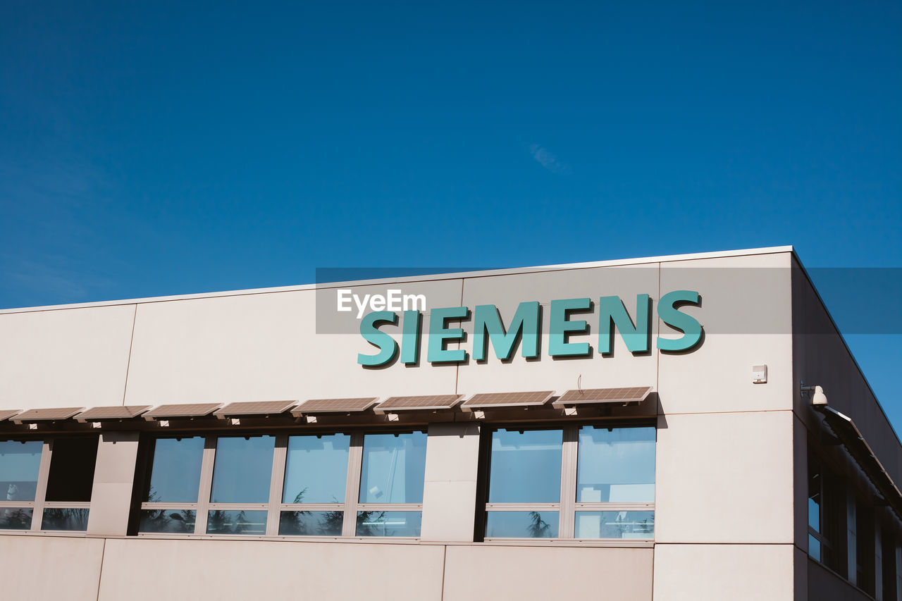 LOW ANGLE VIEW OF SIGN AGAINST BLUE SKY