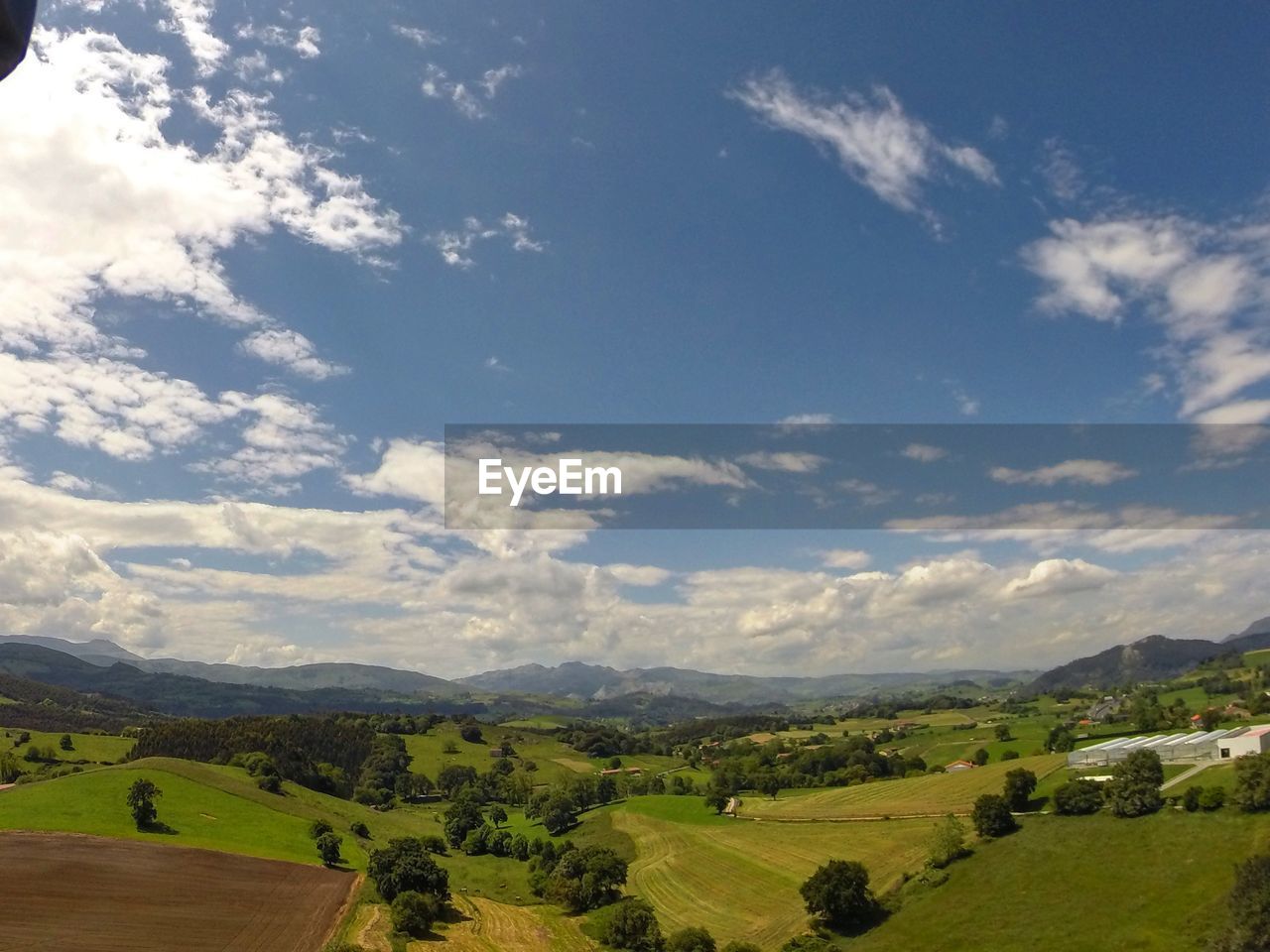 Scenic view of landscape against cloudy sky