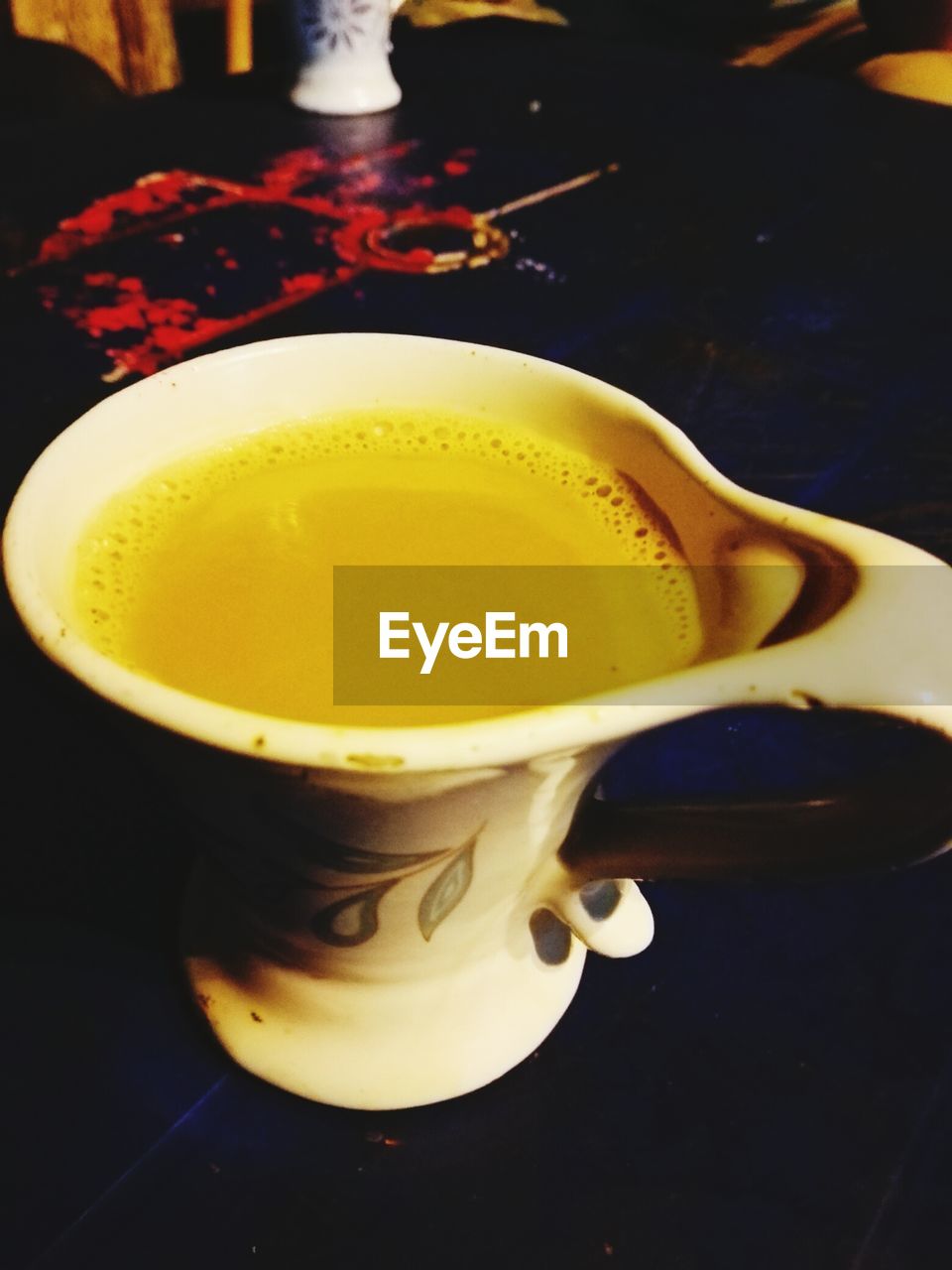 CLOSE-UP OF COFFEE CUP ON TABLE