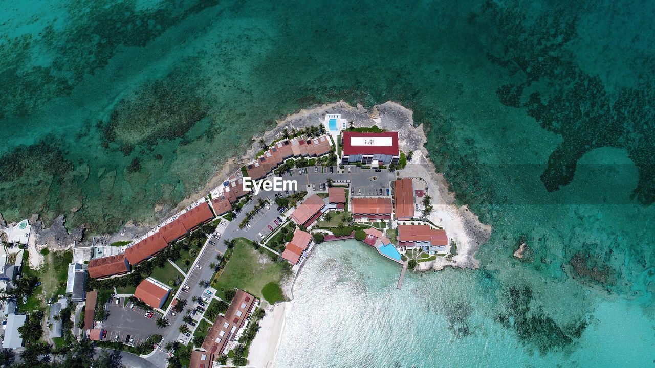 HIGH ANGLE VIEW OF SWIMMING POOL BY BUILDING