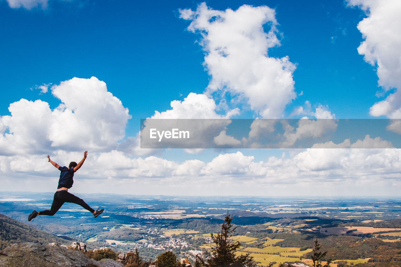 Young man jumps off a cliff into his future. a young boy's giant leap on the jizera rocks. 