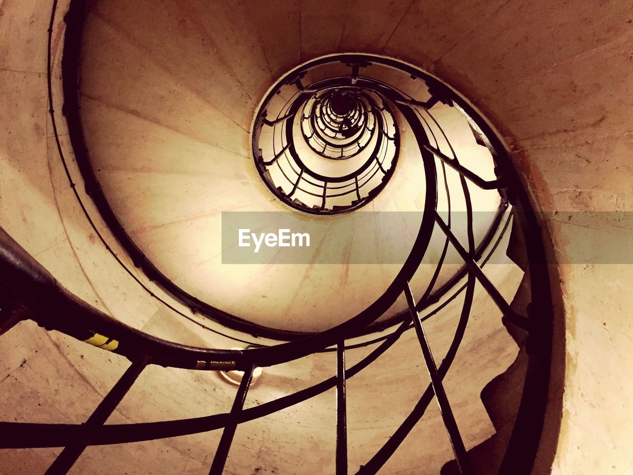 LOW ANGLE VIEW OF SPIRAL STAIRS AGAINST SKY