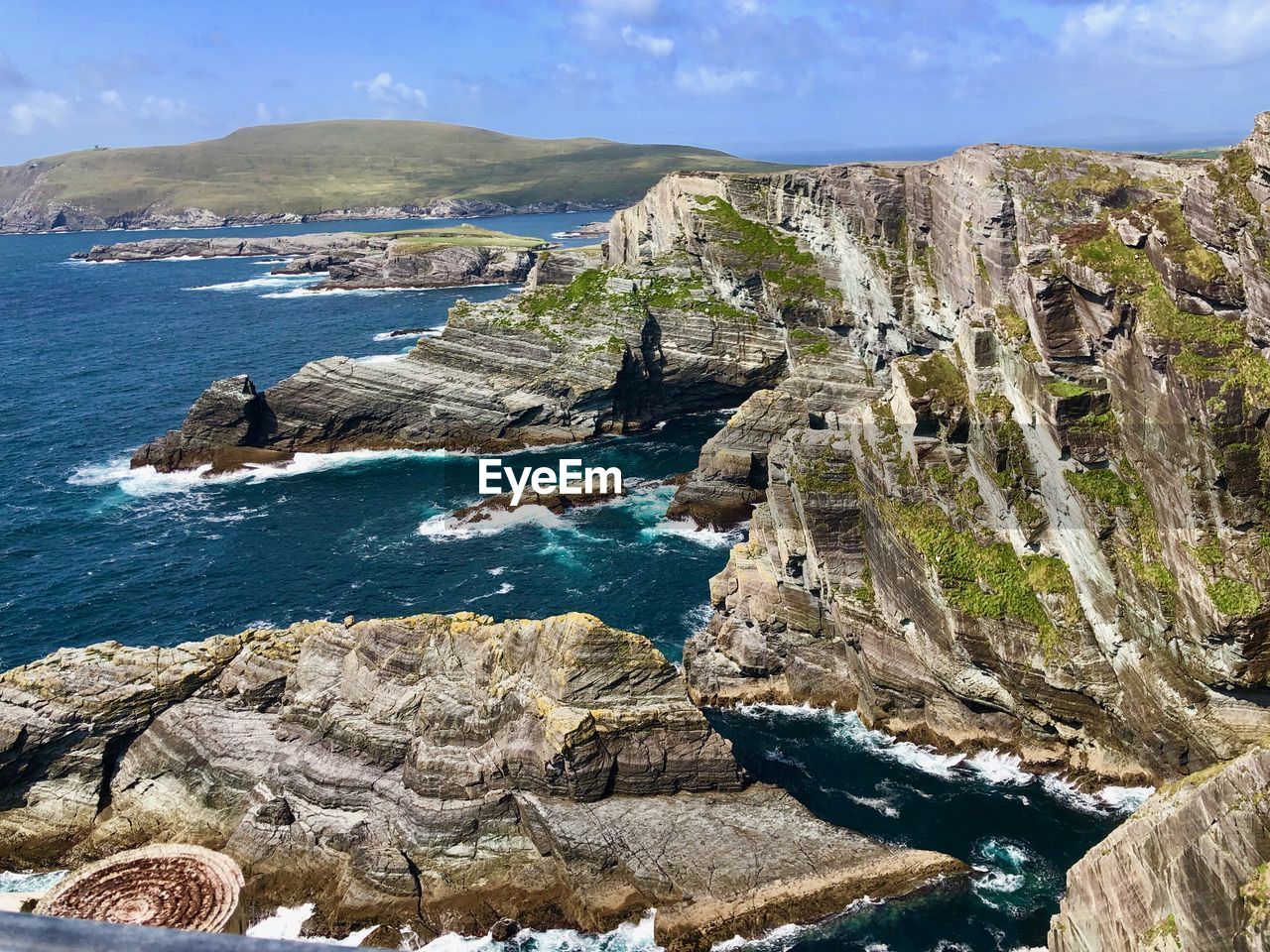 Rock formations by sea against sky