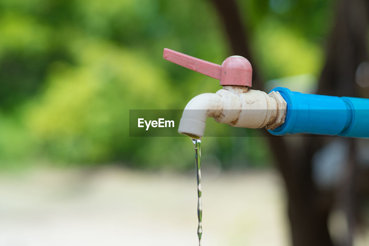 CLOSE-UP OF WATER DROPS ON FAUCET