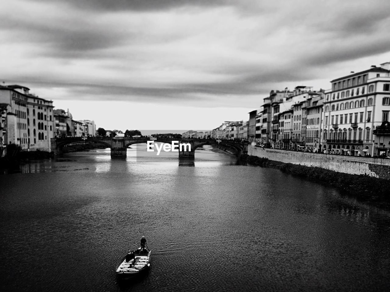 Bridge over river in city against sky