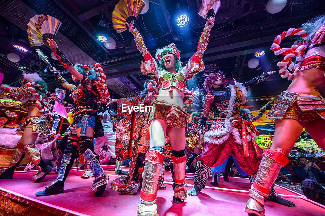 LOW ANGLE VIEW OF MULTI COLORED DANCING IN NIGHTCLUB