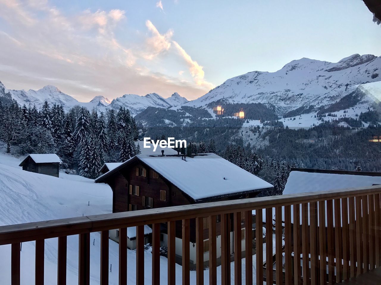 SNOW COVERED ROOF AGAINST MOUNTAINS