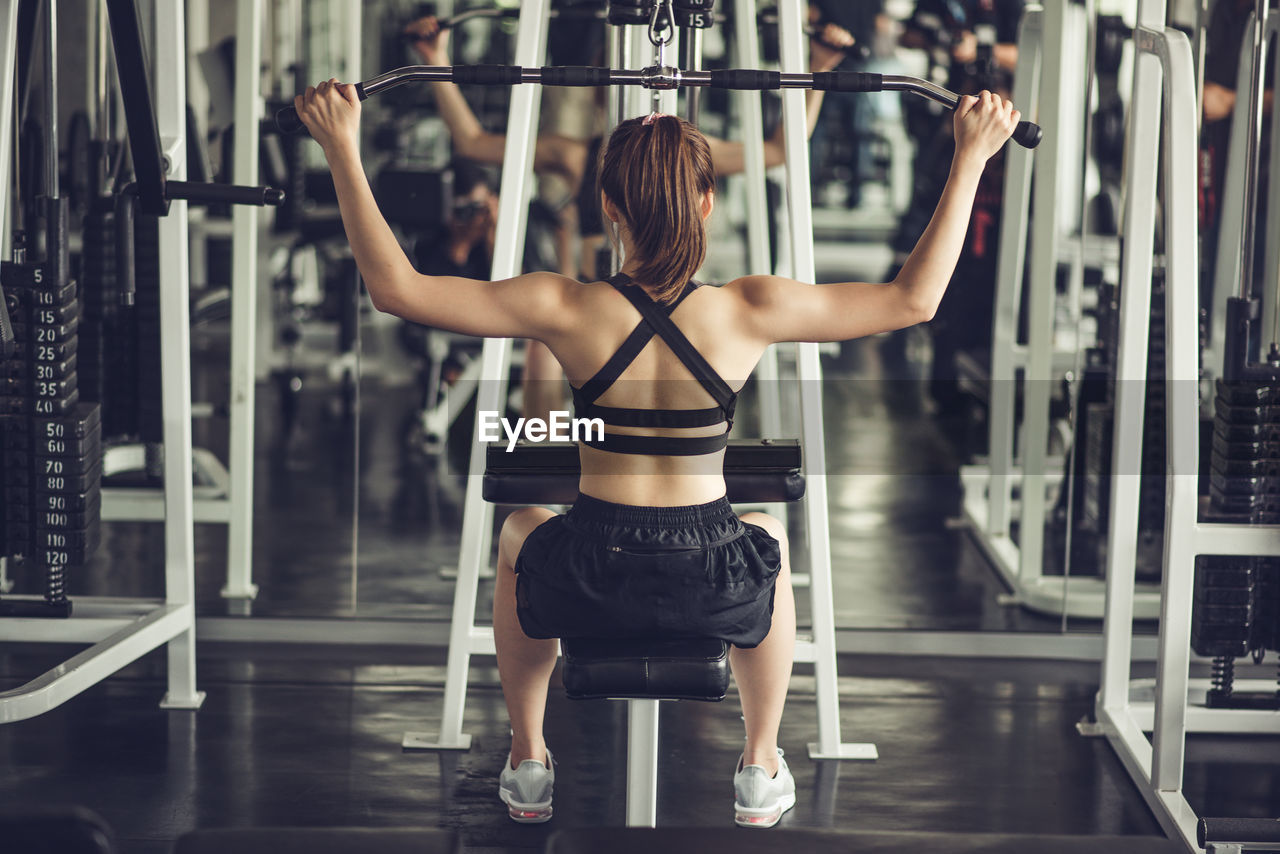 Young woman exercising in gym