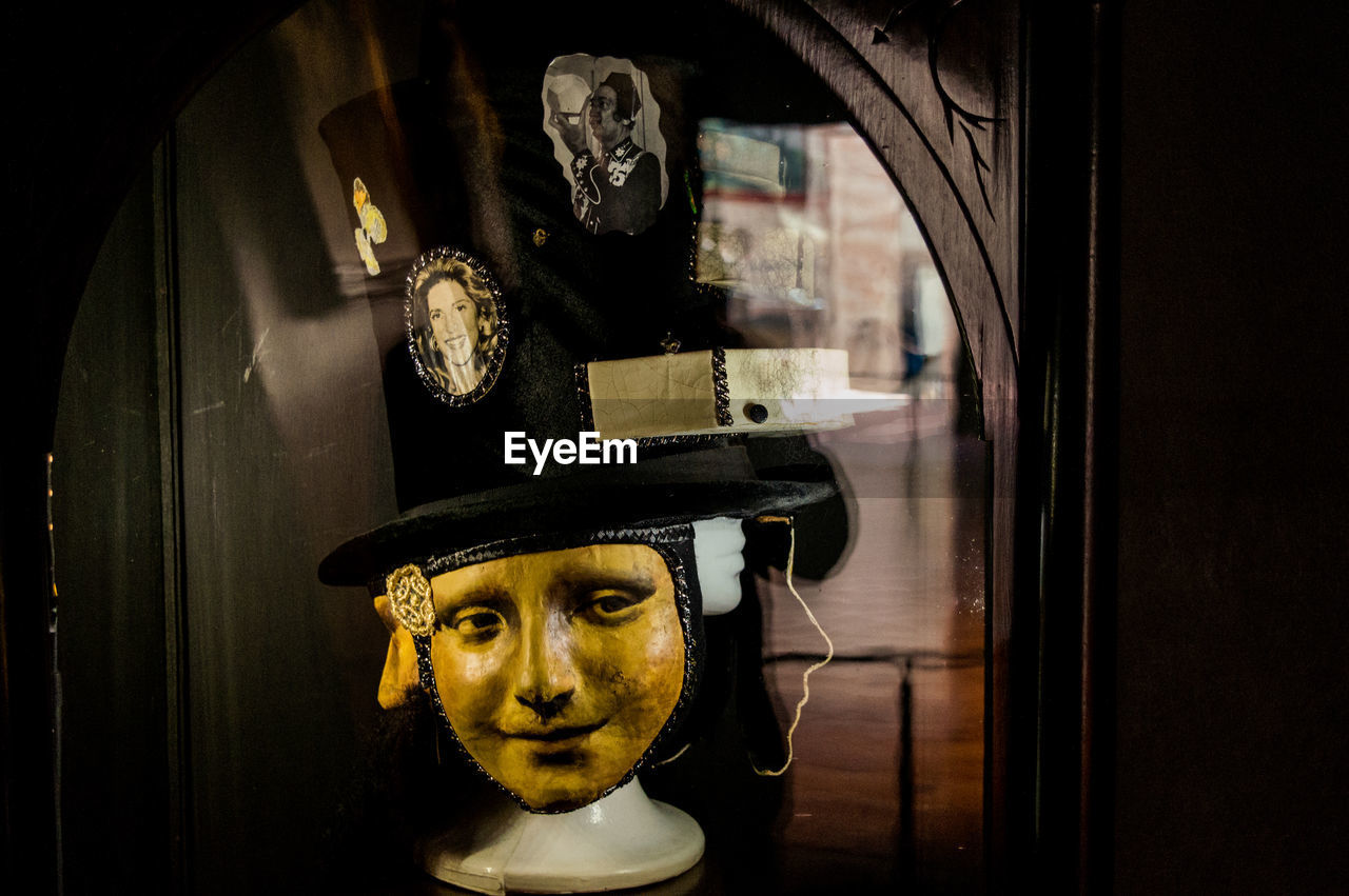 PORTRAIT OF MAN WEARING SUNGLASSES STANDING AGAINST WINDOW