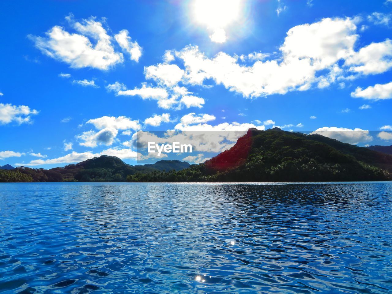 SCENIC VIEW OF LAKE BY MOUNTAIN AGAINST SKY