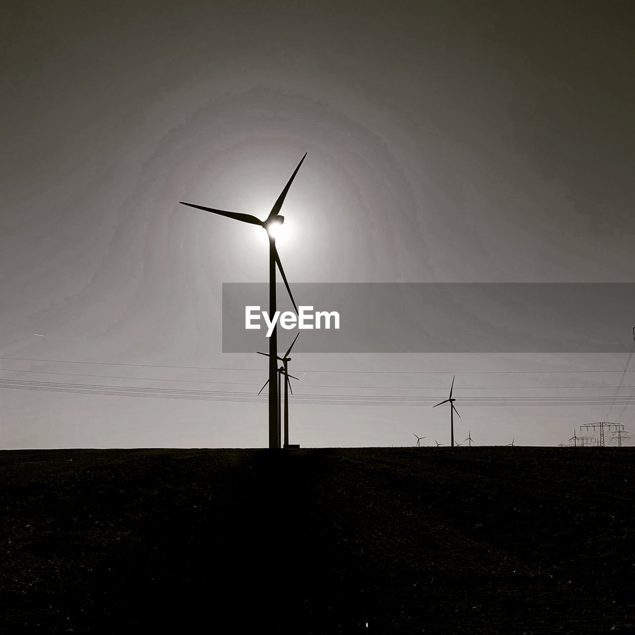 LOW ANGLE VIEW OF WIND TURBINES ON LAND