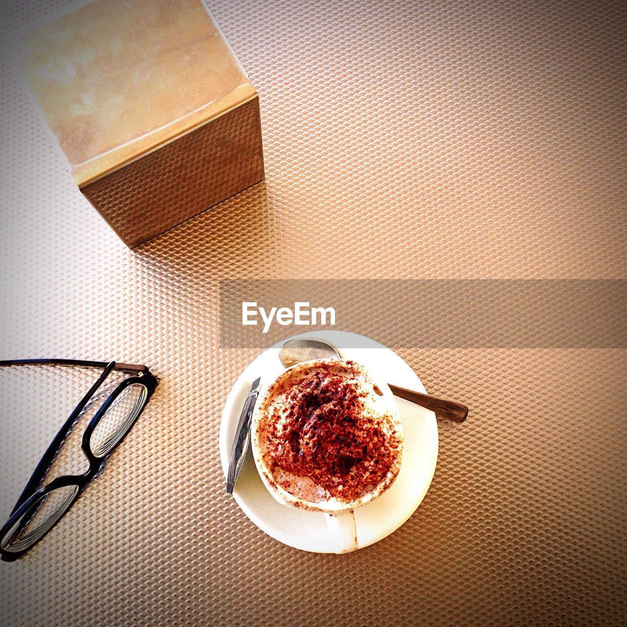 High angle view of coffee and eyeglasses on table