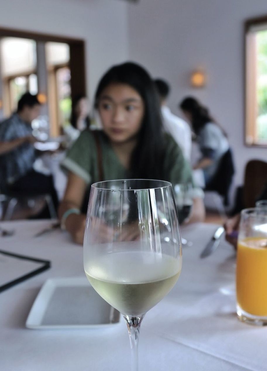 WOMAN SITTING ON DINING TABLE IN RESTAURANT