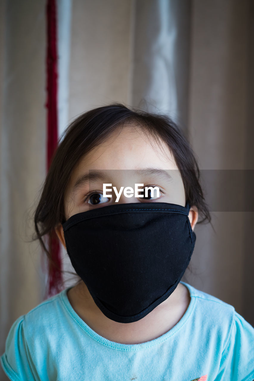 Girl wearing mask at home