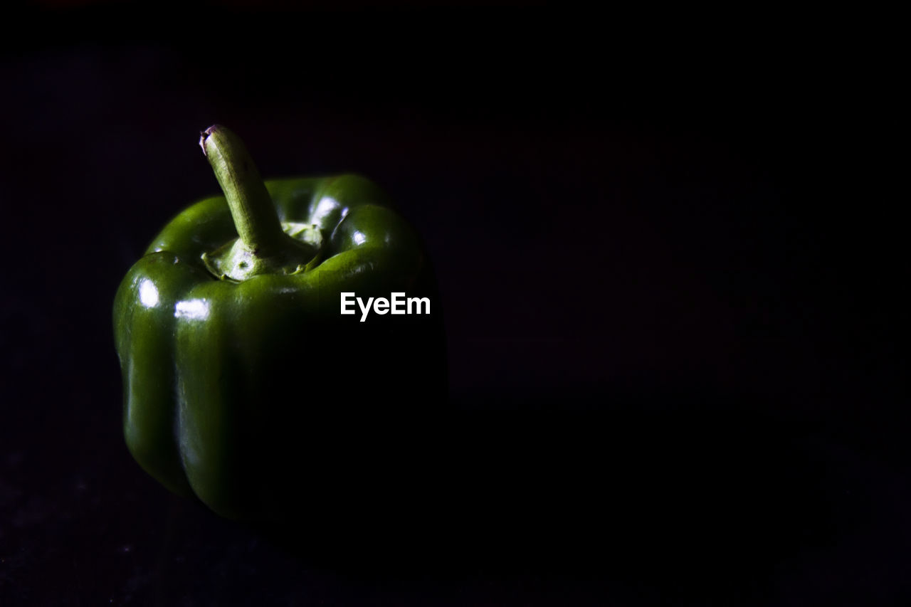 CLOSE-UP OF LEMON OVER BLACK BACKGROUND