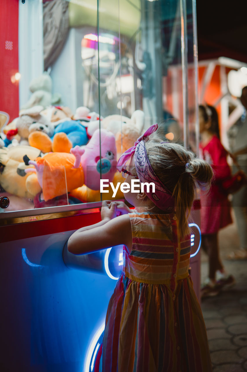 Little girl on the lucky claw machine