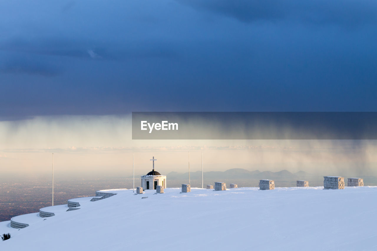 WHITE SNOW COVERED LANDSCAPE AGAINST SKY