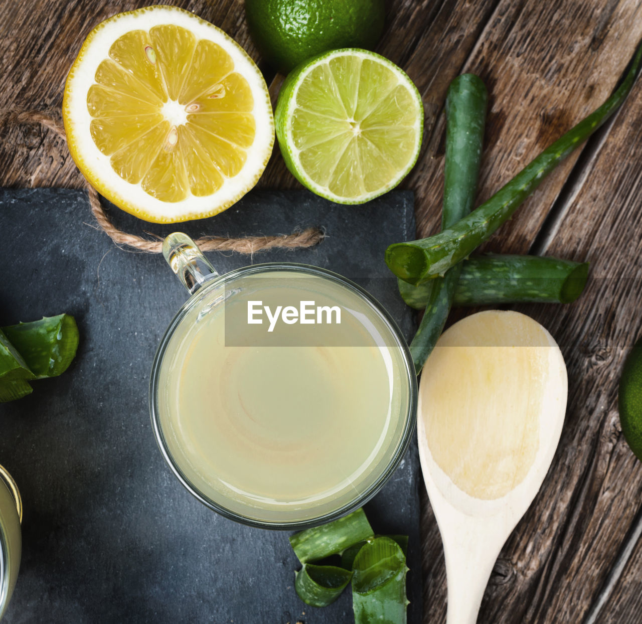 Drink aloe vera with lime and lemon. glass cups on a slate tray.