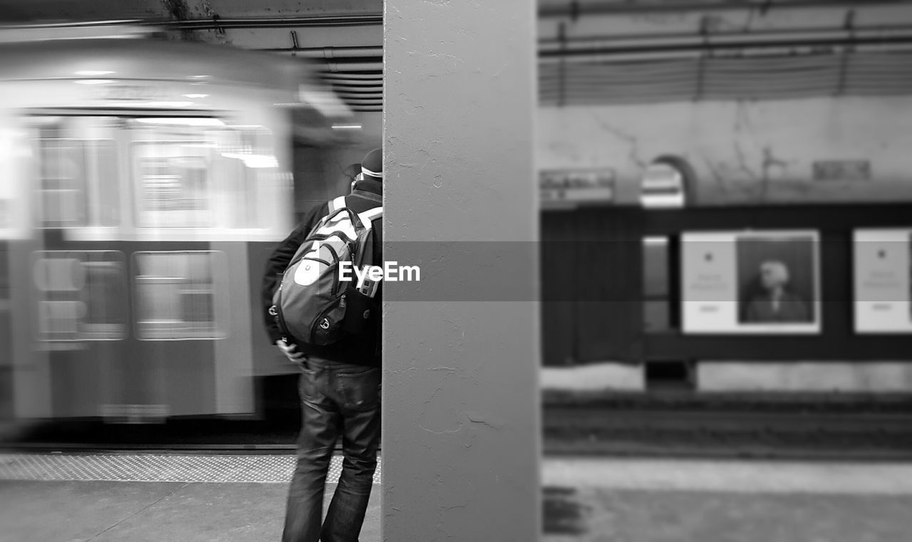 MAN IN TRAIN AT RAILROAD STATION PLATFORM