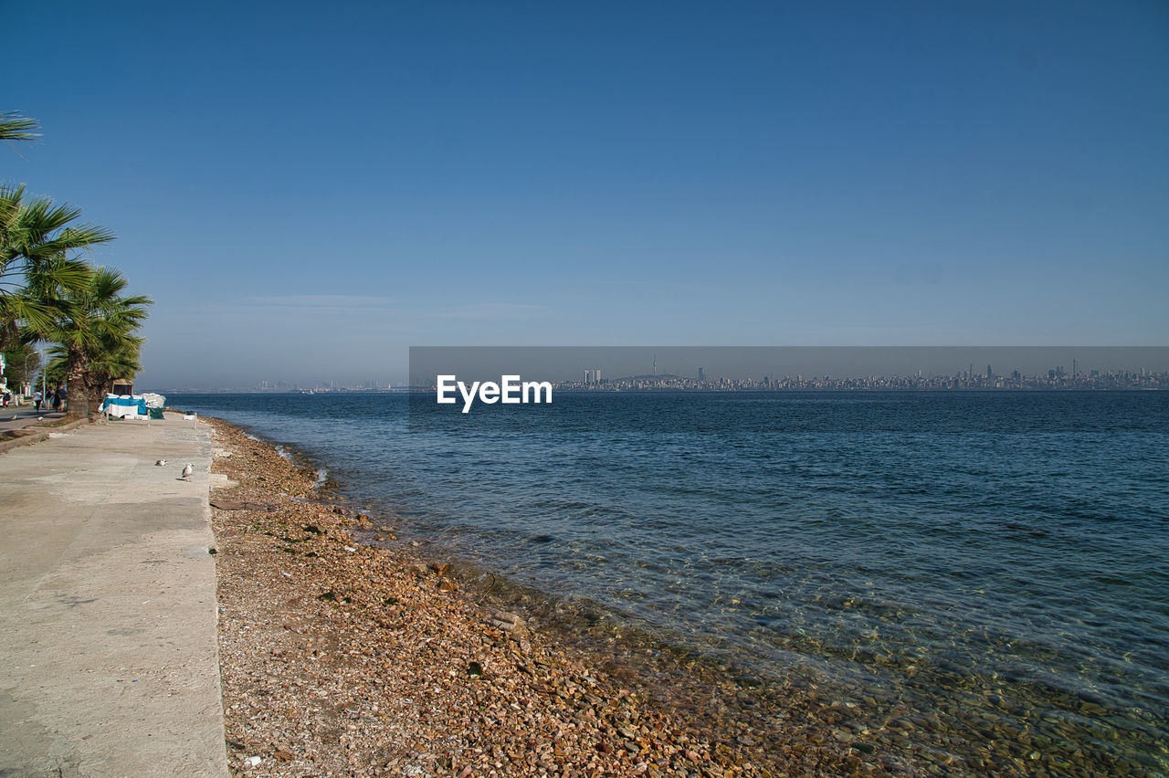 Scenic view of sea against clear blue sky