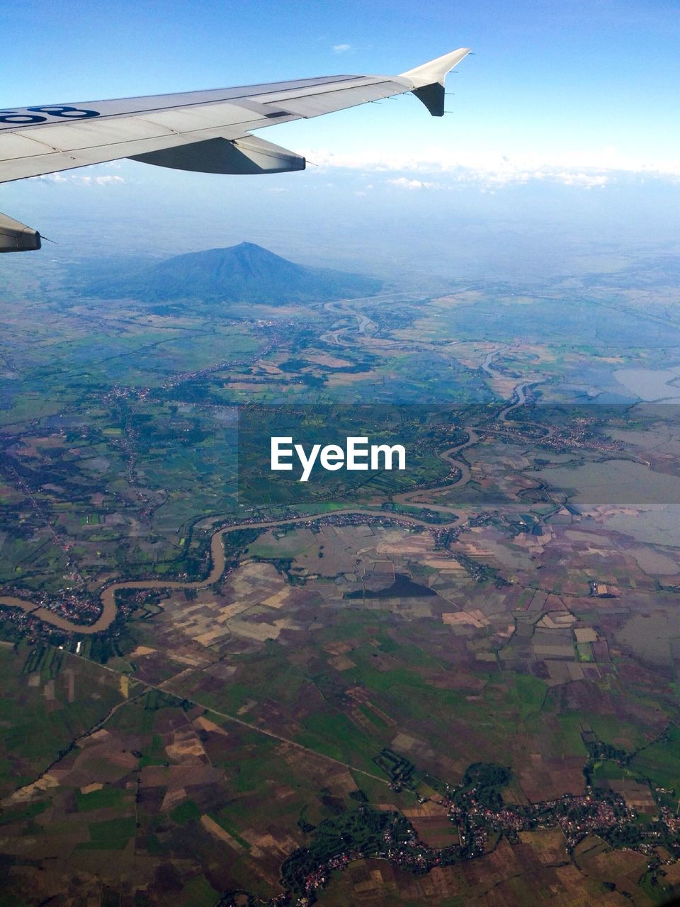 Cropped aircraft wing over mountain landscape