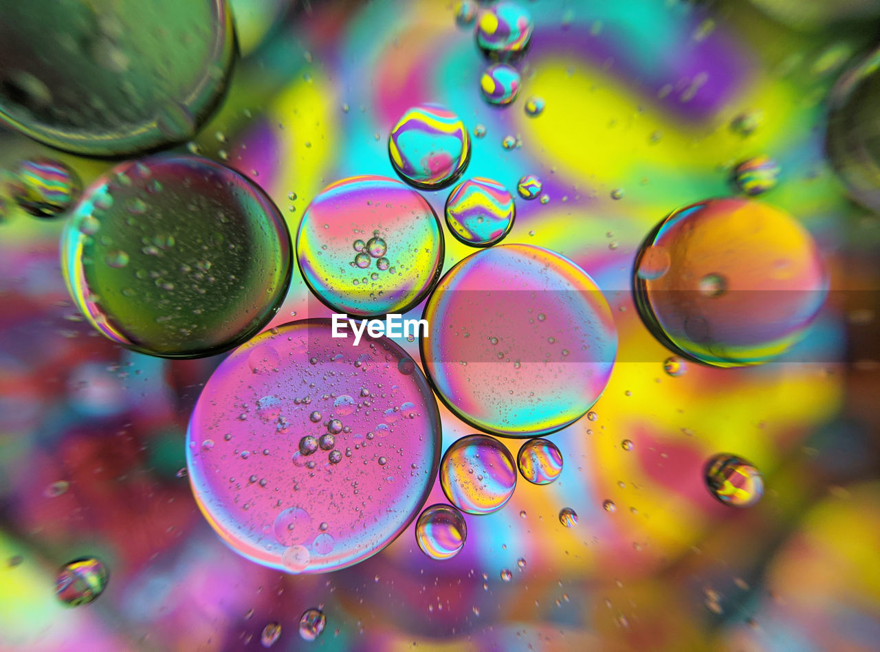 Colorful bubbles abstract background, oil bubbles in transparent liquid backdrop