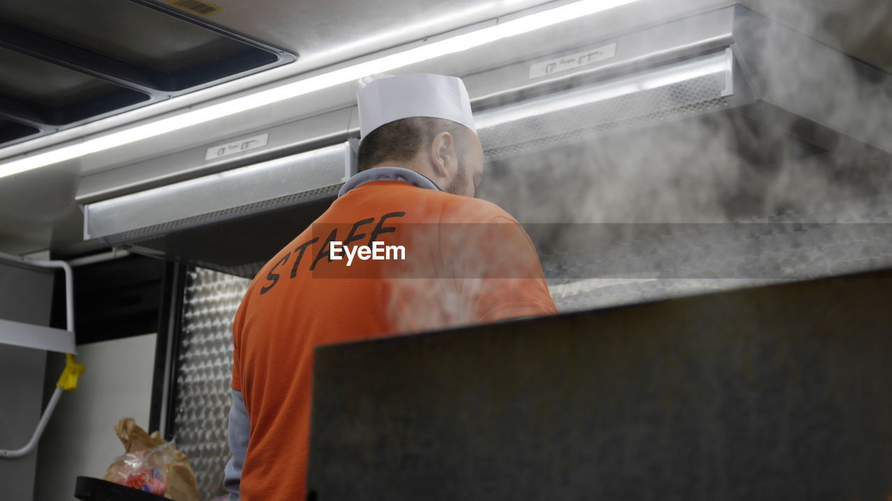 Low angle view of man working in commercial kitchen