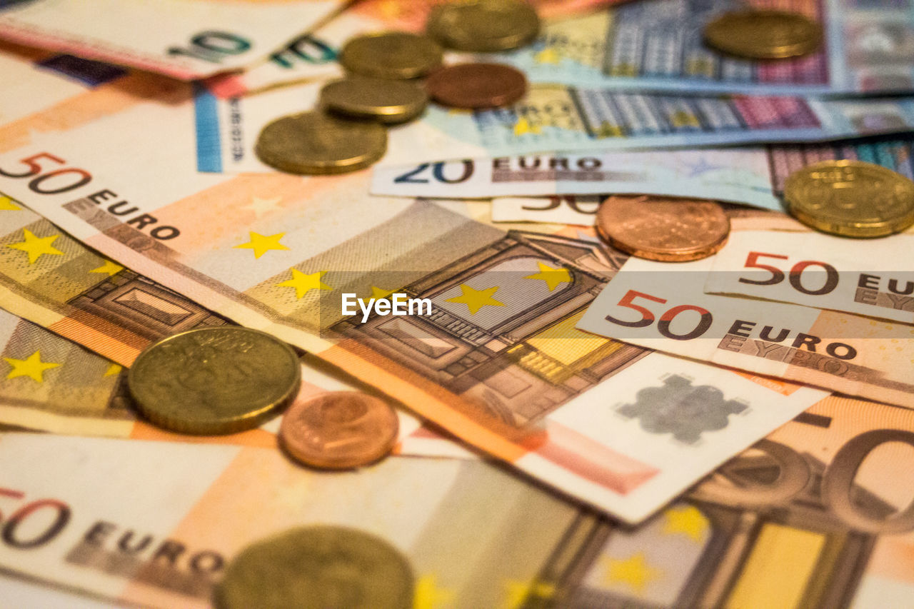 A composition of euro banknotes and coins. eu, eur