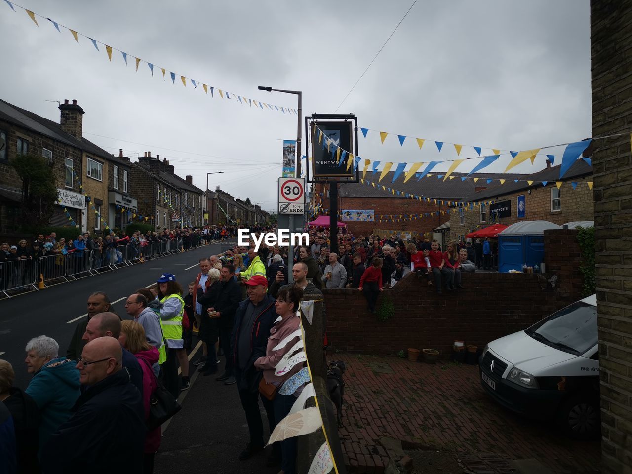 PEOPLE ON STREET AGAINST SKY