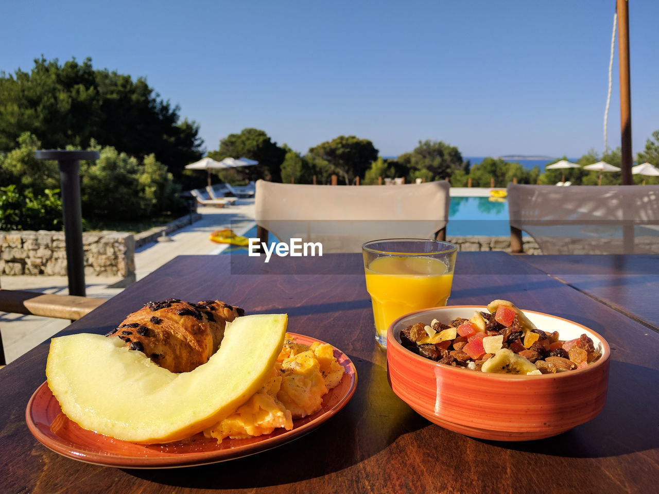 Close-up of food and drink on table against sky