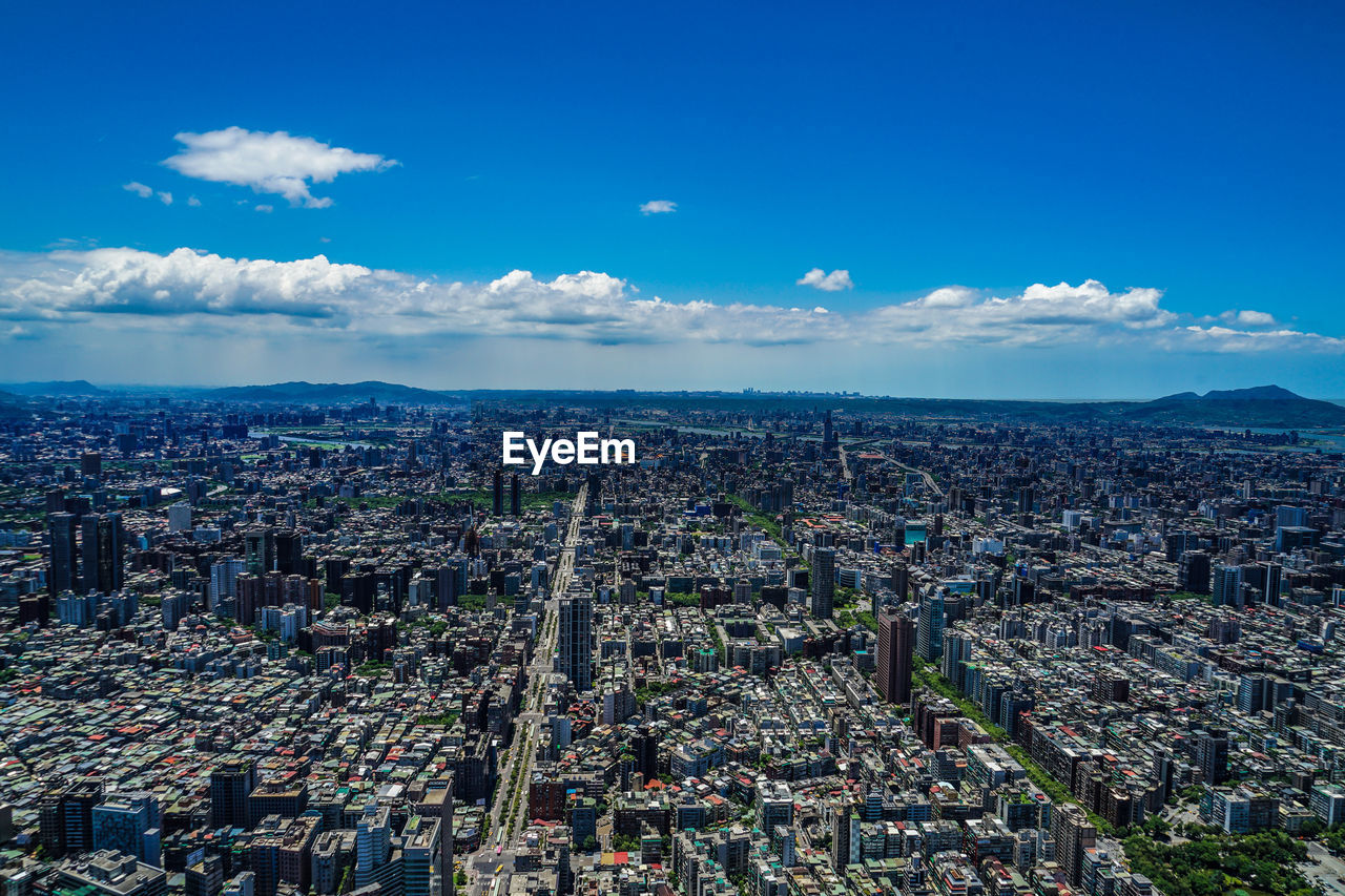 HIGH ANGLE VIEW OF CITY AGAINST SKY