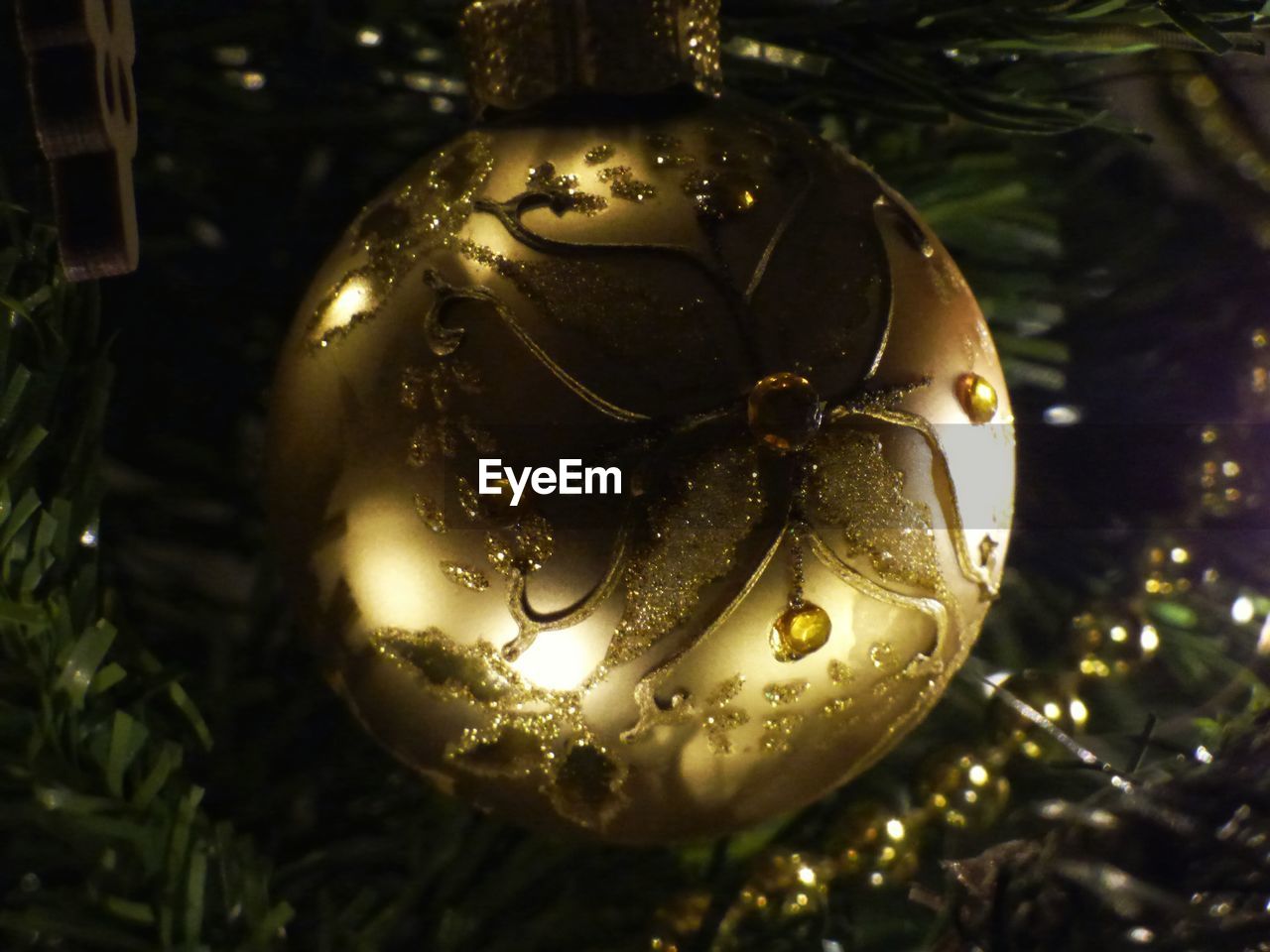 Close-up of golden bauble on christmas tree