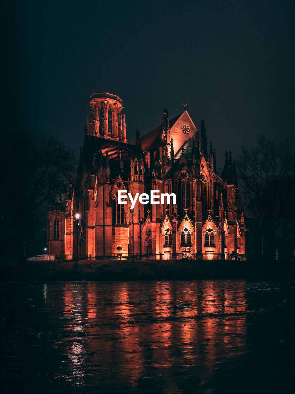 Illuminated church against clear sky at night