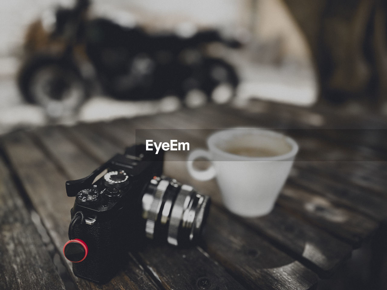 black, camera, wood, table, indoors, no people, cup, digital slr, focus on foreground, technology, drink, close-up, food and drink, still life, mug, coffee, coffee cup, white, tableware