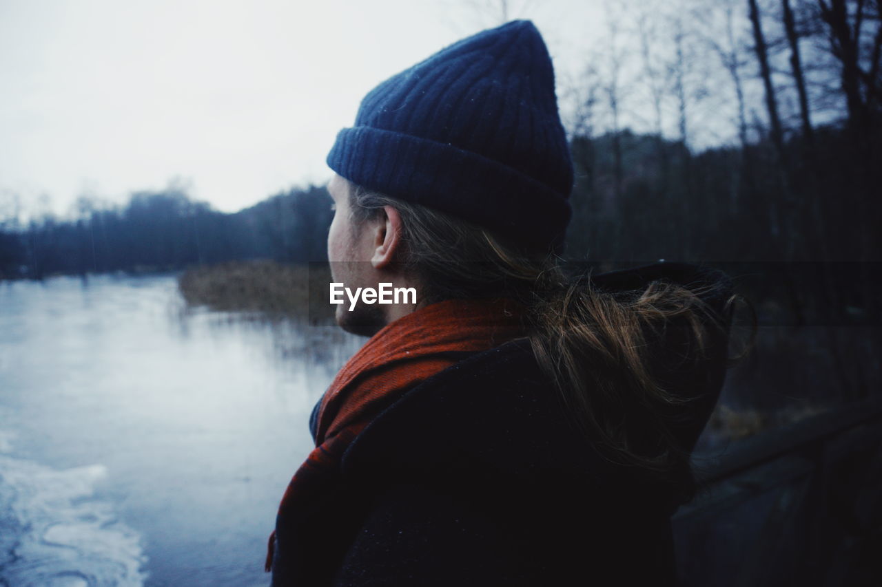 Rear view of man wearing warm clothing in forest