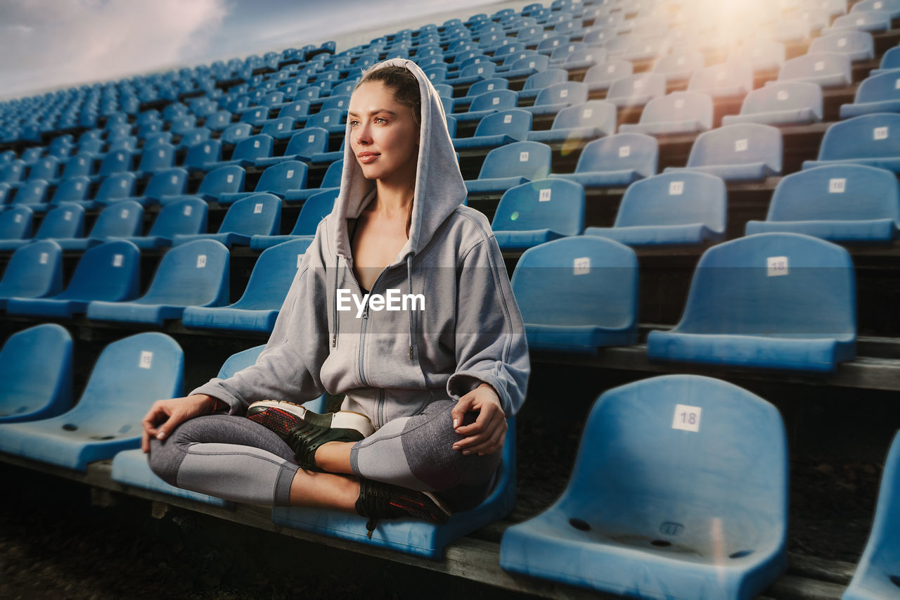 Female athlete sitting at stadium