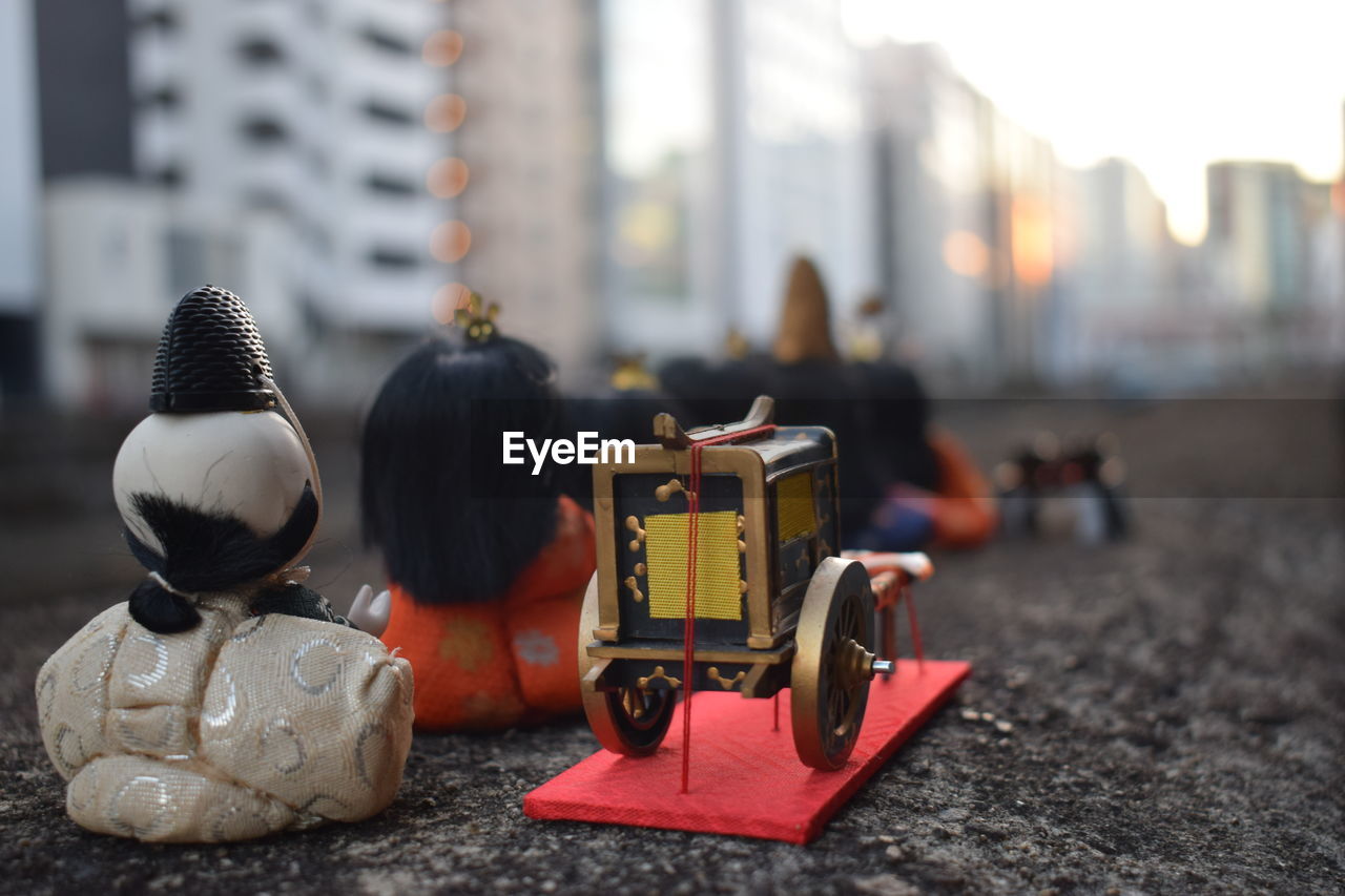 city, architecture, focus on foreground, building exterior, built structure, street, city life, day, vehicle, toy, outdoors, childhood, red, transportation