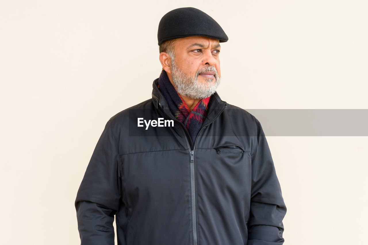 MAN WEARING MASK AGAINST WHITE BACKGROUND