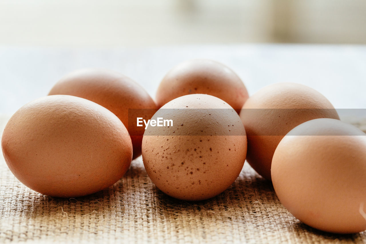 Close-up of brown eggs on burlap