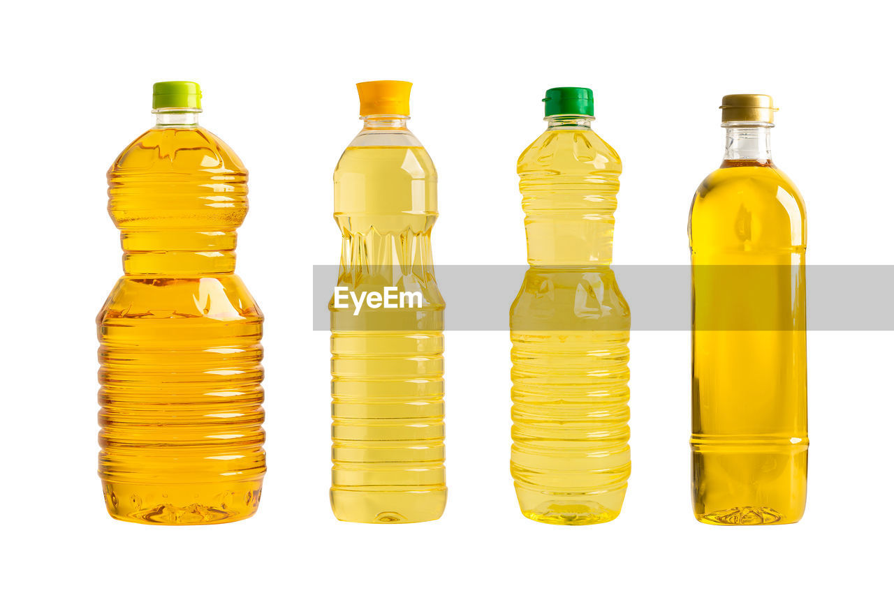 bottle, yellow, container, white background, glass bottle, plastic bottle, cut out, studio shot, drinkware, food and drink, group of objects, in a row, no people, indoors, glass, refreshment