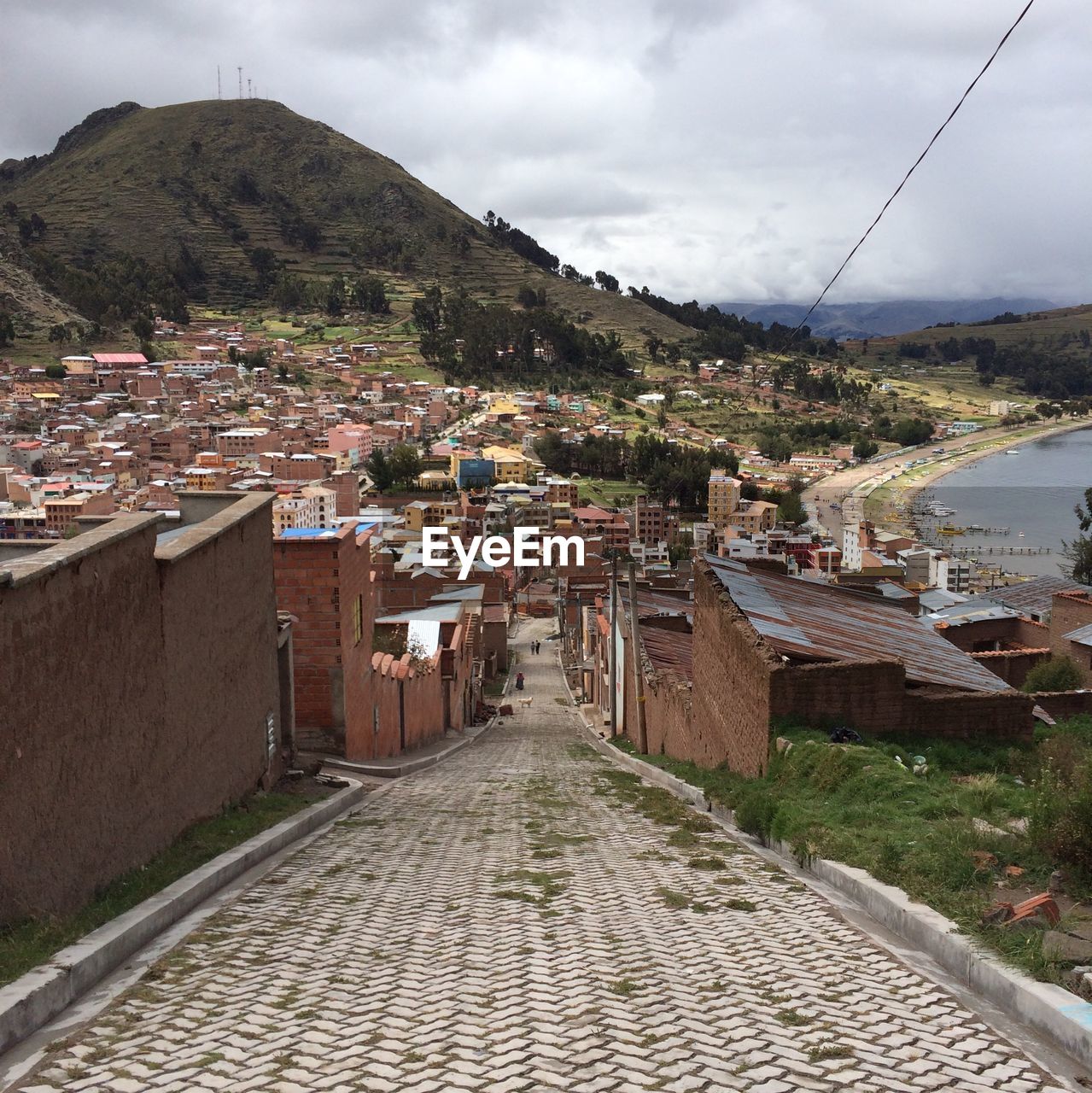 Footpath amidst houses against sky