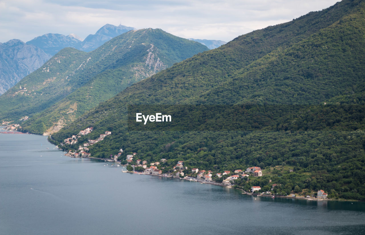 Scenic view of river amidst mountains against sky