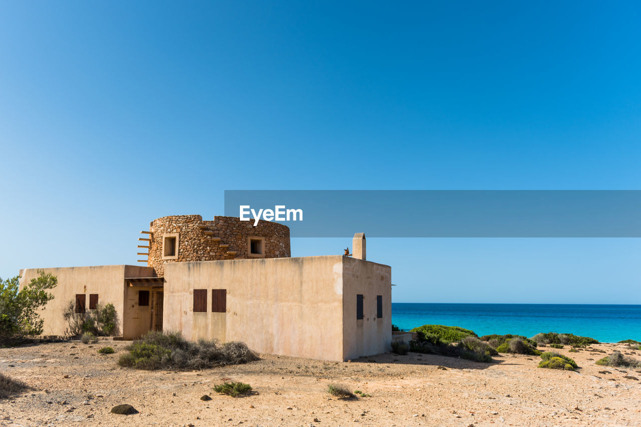 BUILT STRUCTURE ON CLIFF AGAINST CLEAR BLUE SKY