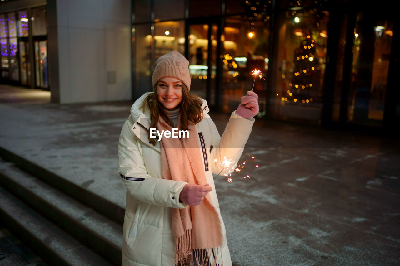 Caucasian white girl with sparklers christmas shopping