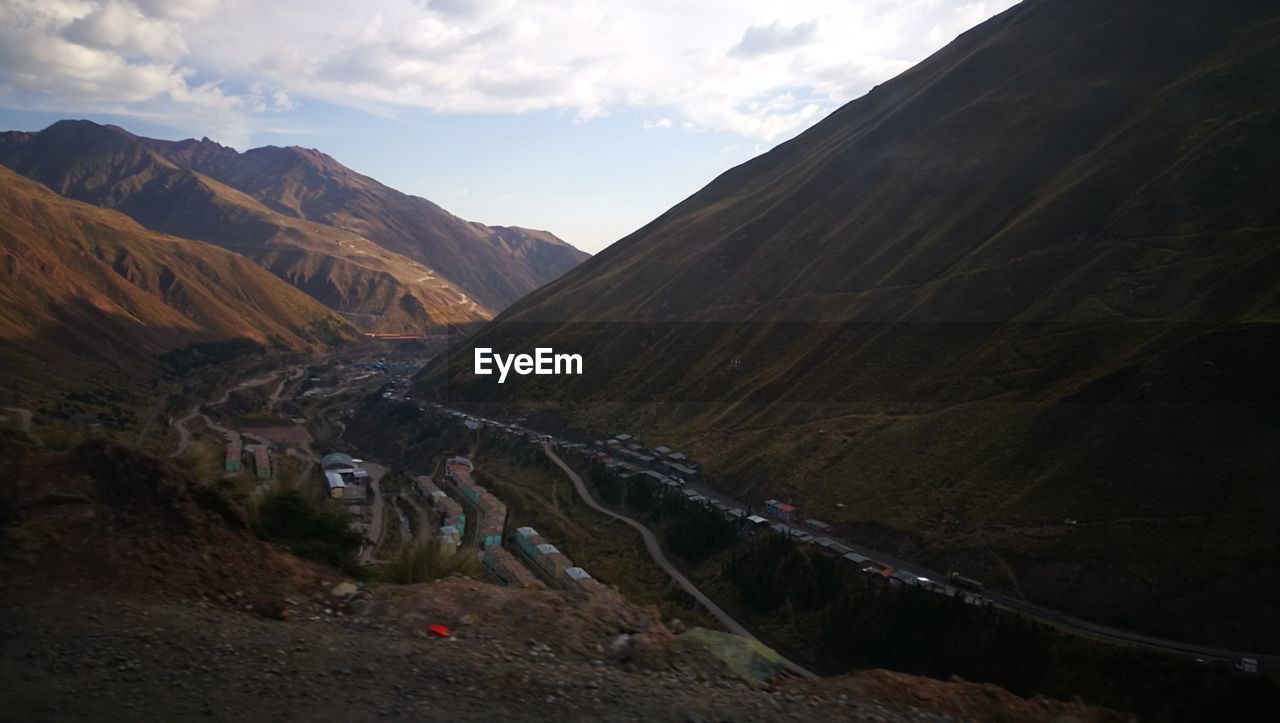 Scenic view of mountains against cloudy sky