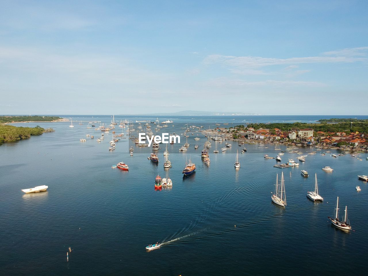 High angle view of boats on sea shore against sky