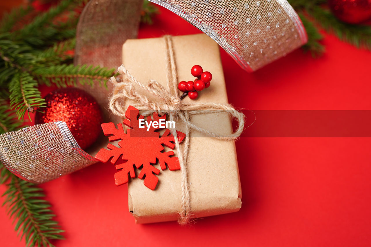 CLOSE-UP OF CHRISTMAS DECORATIONS ON RED TABLE