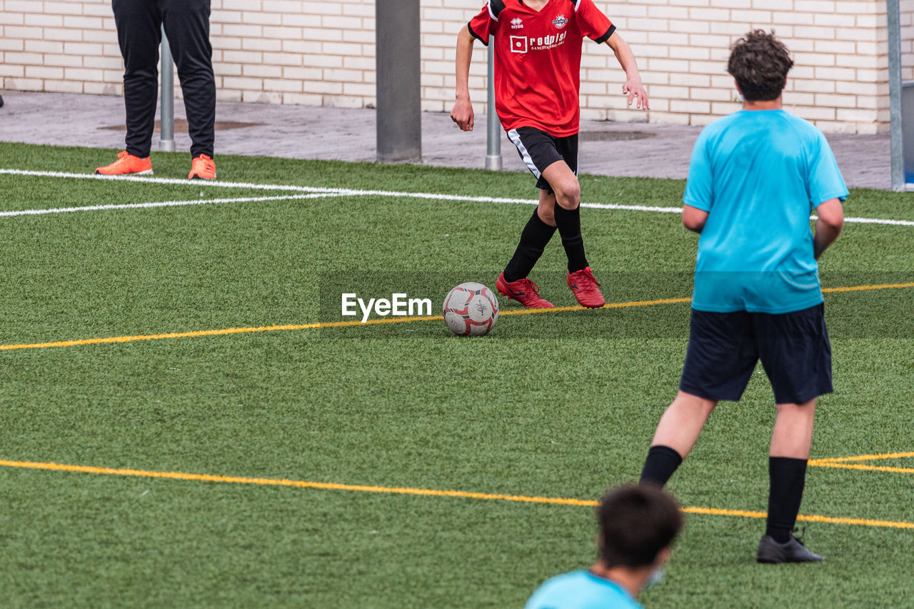 rear view of man playing soccer