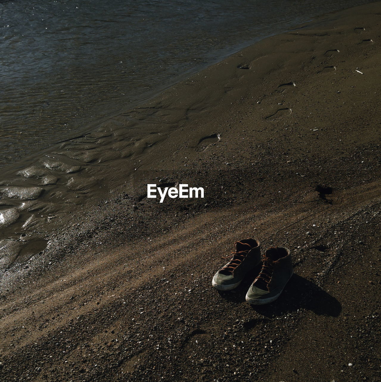 High angle view of shoes on sea shore