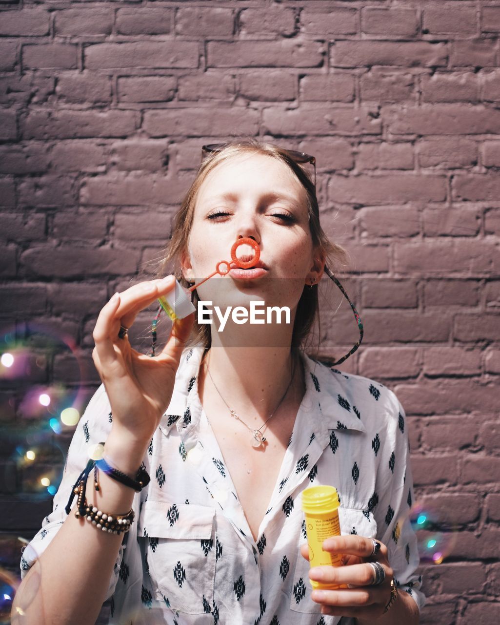 Young woman blowing bubbles